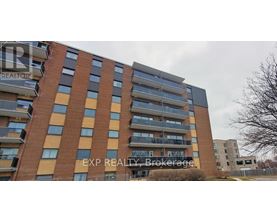 A tall apartment building with the words EXP REALTY Brokerage on the side.