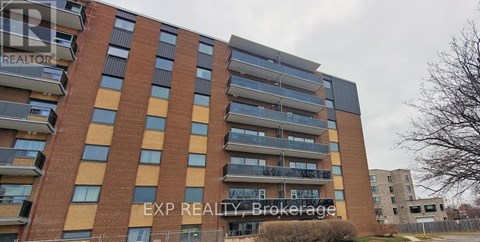 A tall apartment building with the words EXP REALTY Brokerage on the side.