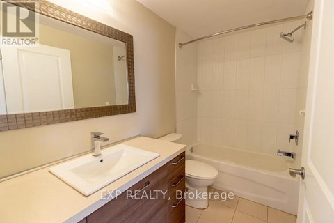 A bathroom with a sink, toilet, and bathtub.