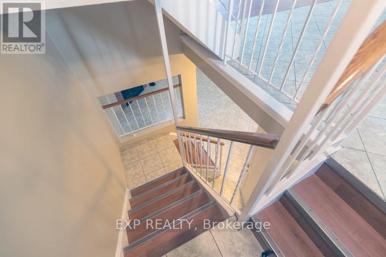 A staircase with a glass railing and wooden steps.