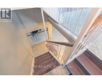 A staircase with a glass railing and wooden steps.
