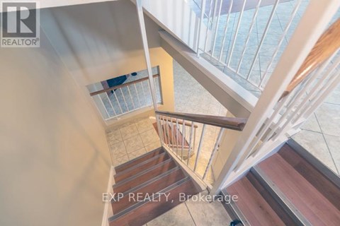 A staircase with a glass railing and wooden steps.