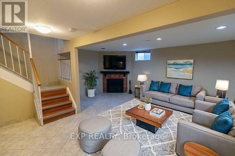 A living room with a couch, coffee table, and staircase.