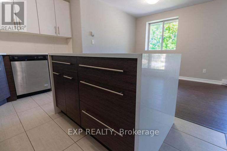 A kitchen with white cabinets and a stainless steel dishwasher.