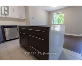 A kitchen with white cabinets and a stainless steel dishwasher.