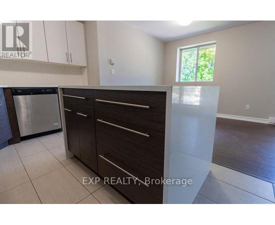 A kitchen with white cabinets and a stainless steel dishwasher.