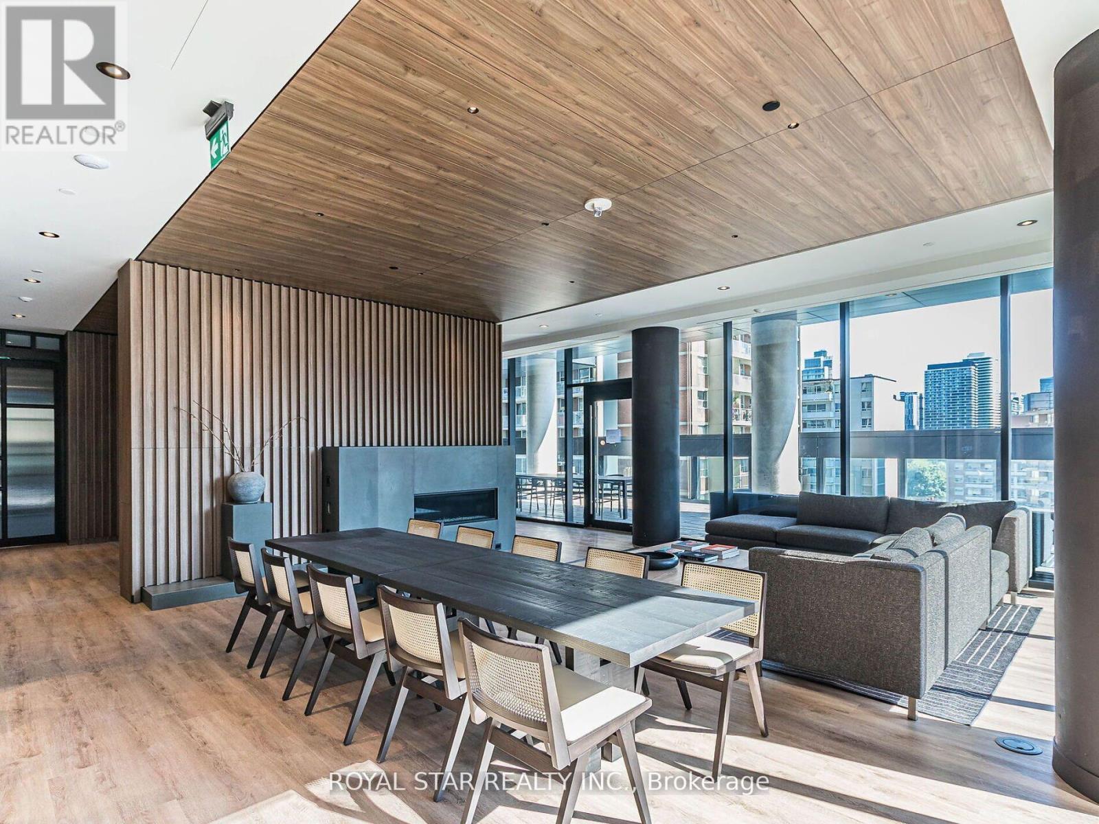 A modern dining room with a long table and chairs.