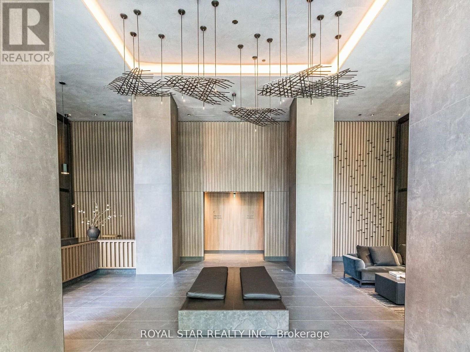 A modern interior space with a fireplace and a hanging sculpture.