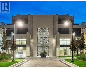 A modern building with a large glass door and the logo "REALTOR" on the top left corner.