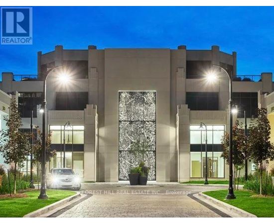 A modern building with a large glass door and the logo "REALTOR" on the top left corner.