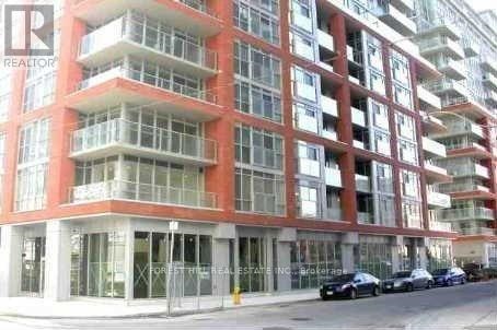 A multi-story building with a red facade and balconies.