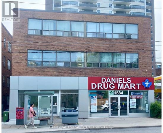 A Daniel's Drug Mart storefront with a man walking by.