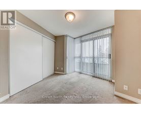 A realtor photo of a bedroom with a sliding door.