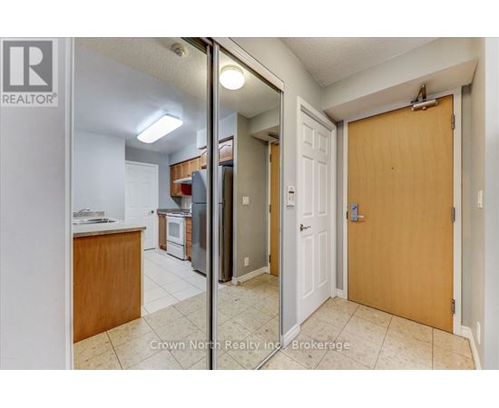 A kitchen with a refrigerator, oven, and sink is shown in a real estate listing.