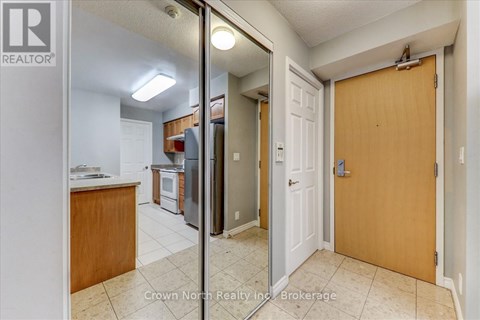 A kitchen with a refrigerator, oven, and sink is shown in a real estate listing.
