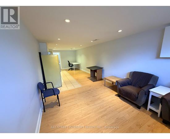 A living room with a blue chair and a brown couch.