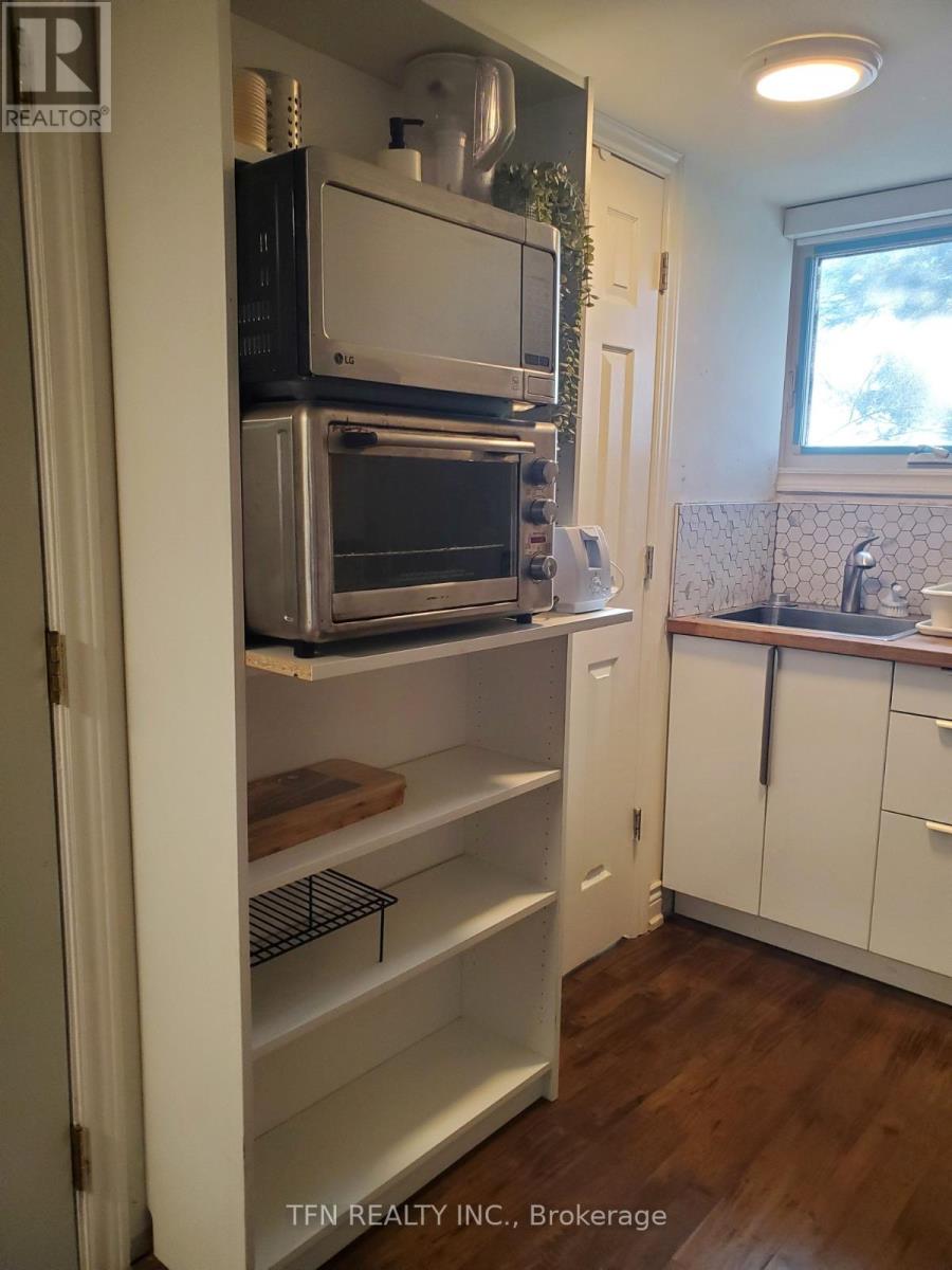 A kitchen with a white fridge and a window.