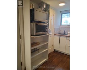 A kitchen with a white fridge and a window.