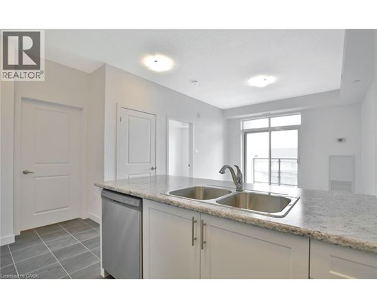 A kitchen with a sink and a window.