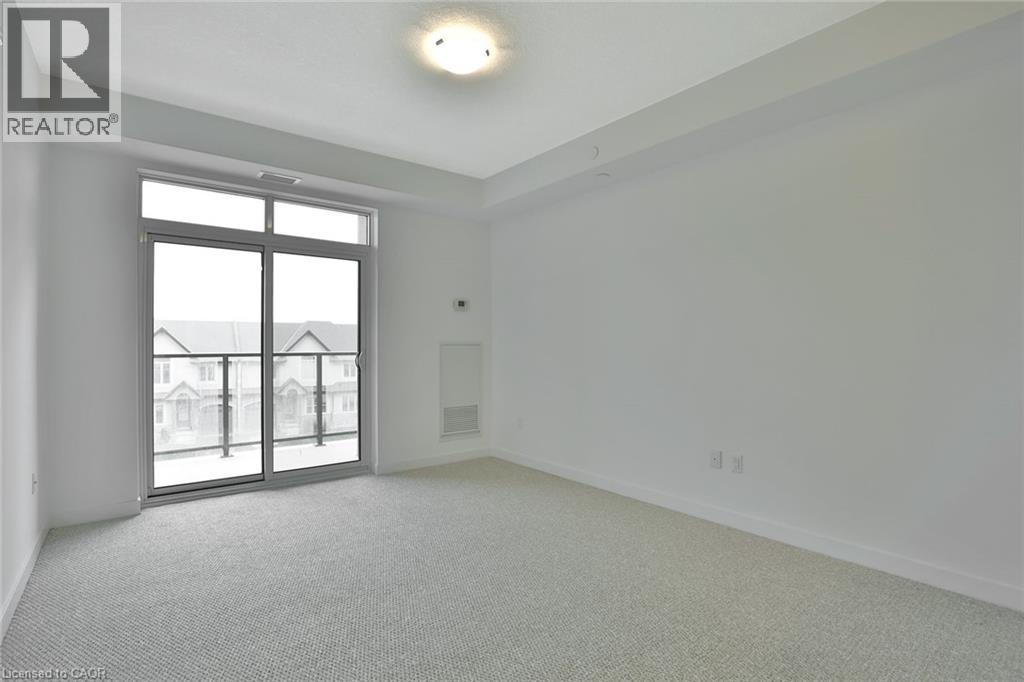 A spacious room with a large window and sliding glass doors.