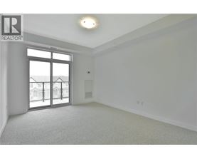 A spacious room with a large window and sliding glass doors.