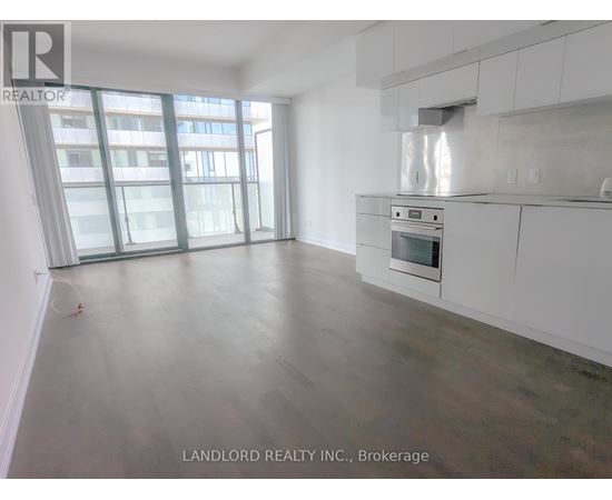 A spacious kitchen with white cabinets and a stainless steel oven.