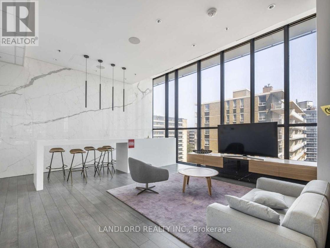 A living room with a white couch and a television.