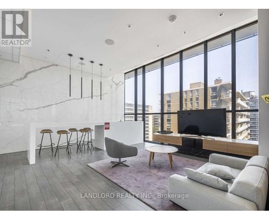 A living room with a white couch and a television.