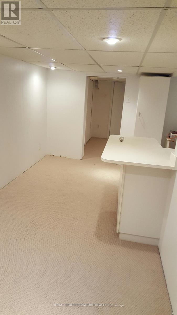 A white room with a desk and a cabinet.