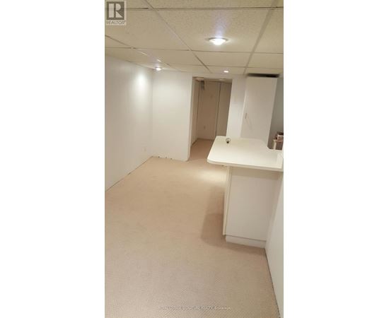 A white room with a desk and a cabinet.