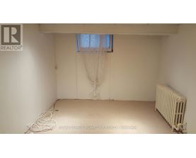 A white room with a window and a radiator.