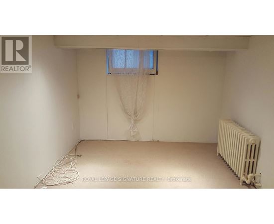 A white room with a window and a radiator.