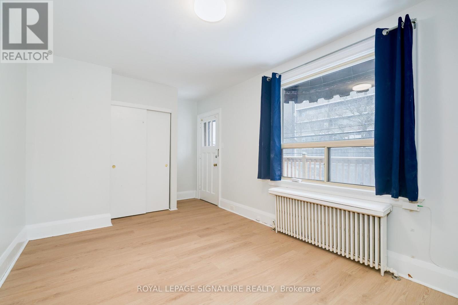 A room with a window and a radiator.