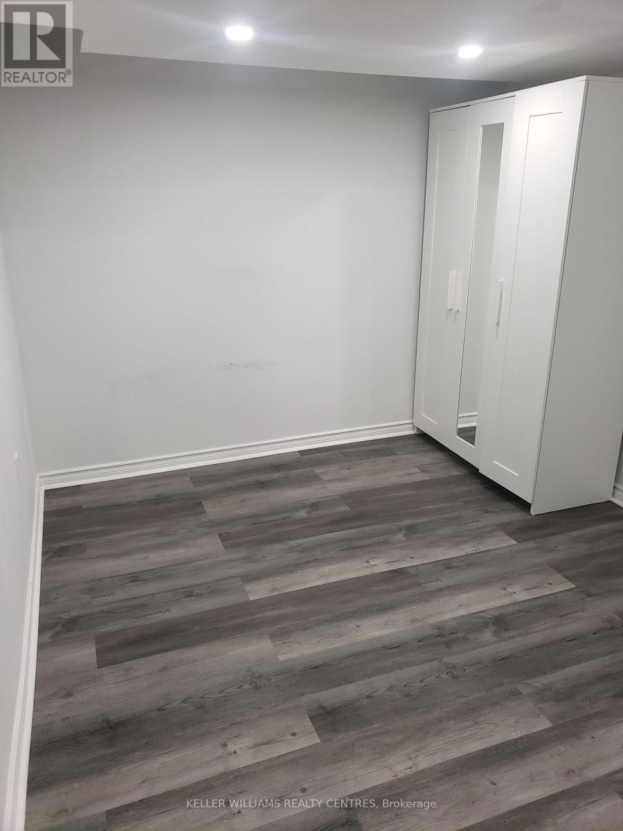 A room with a wooden floor and a white wardrobe.