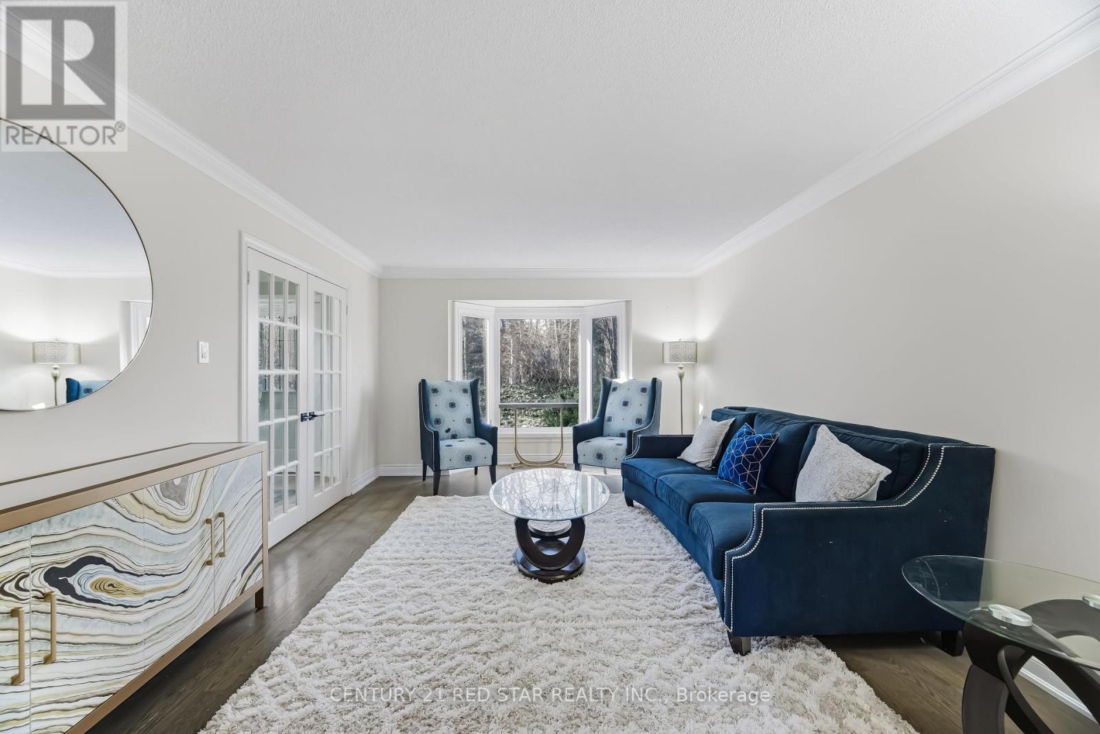 A living room with a blue couch and a coffee table.