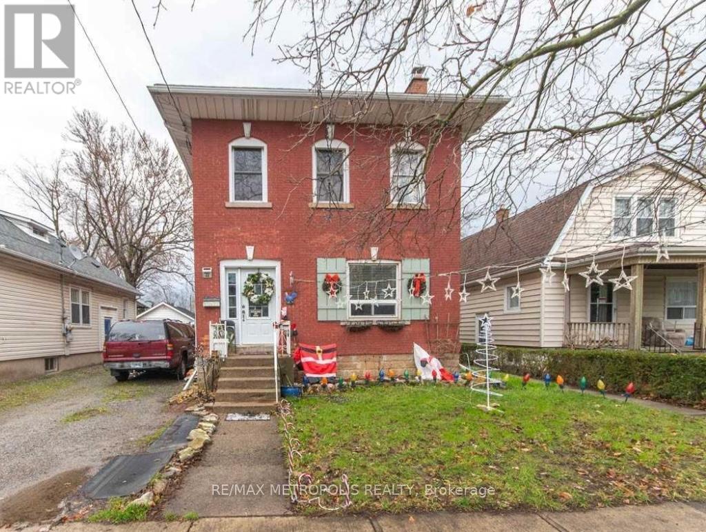 A red brick house with a white door and windows.