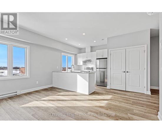 A kitchen with white appliances and cabinets is shown.