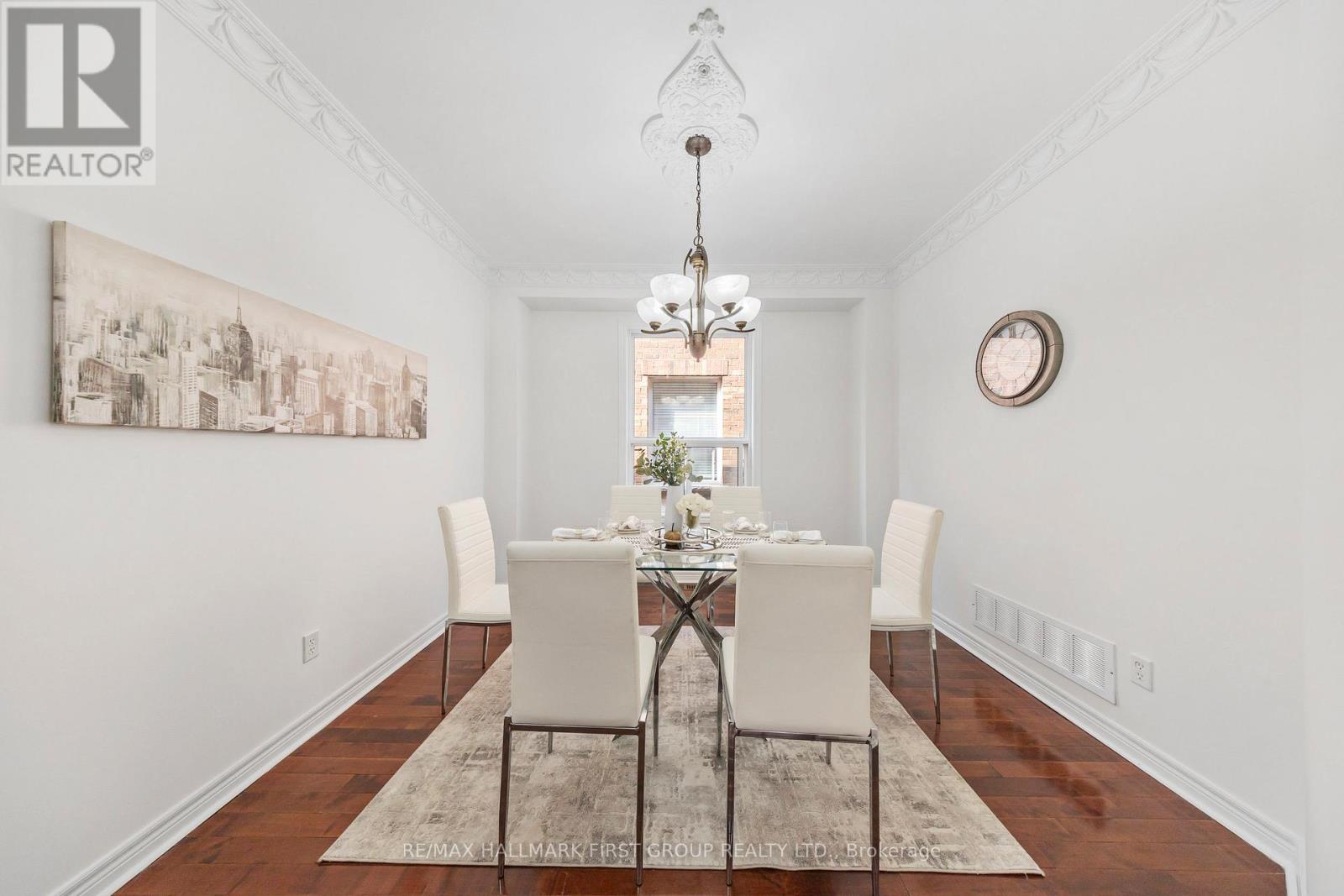 A dining room with a table set for four.