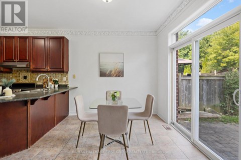 A kitchen with a dining table and chairs.