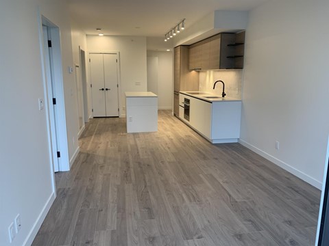 A kitchen area with a sink and a refrigerator.