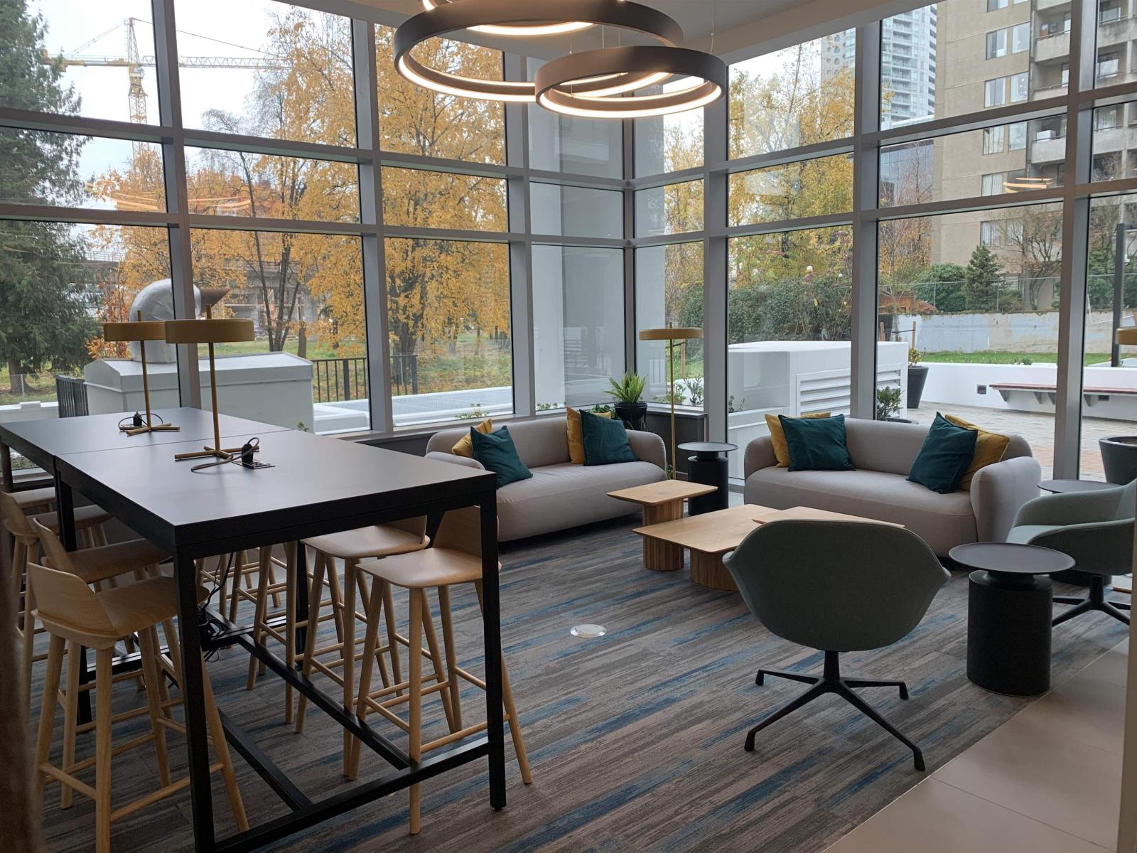 A modern dining area with a long table and chairs.