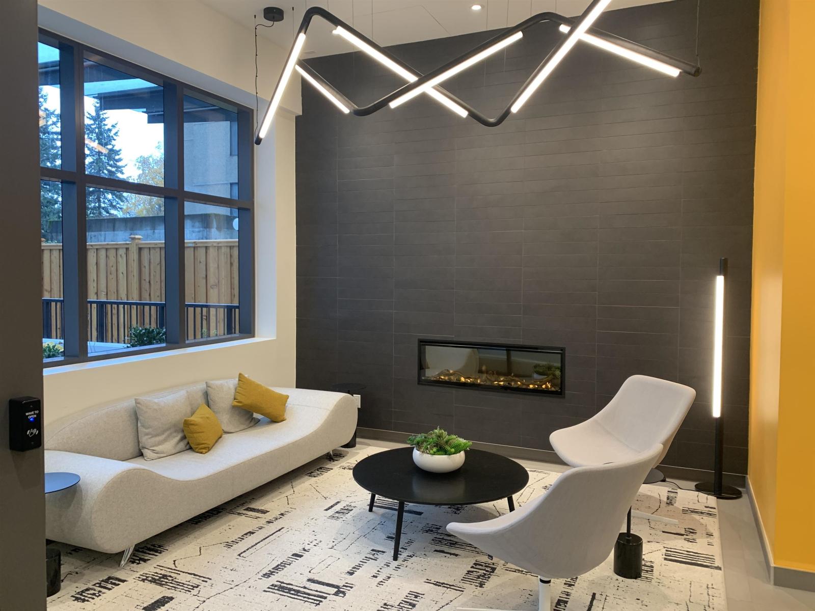A modern living room with a fireplace and a white sofa.
