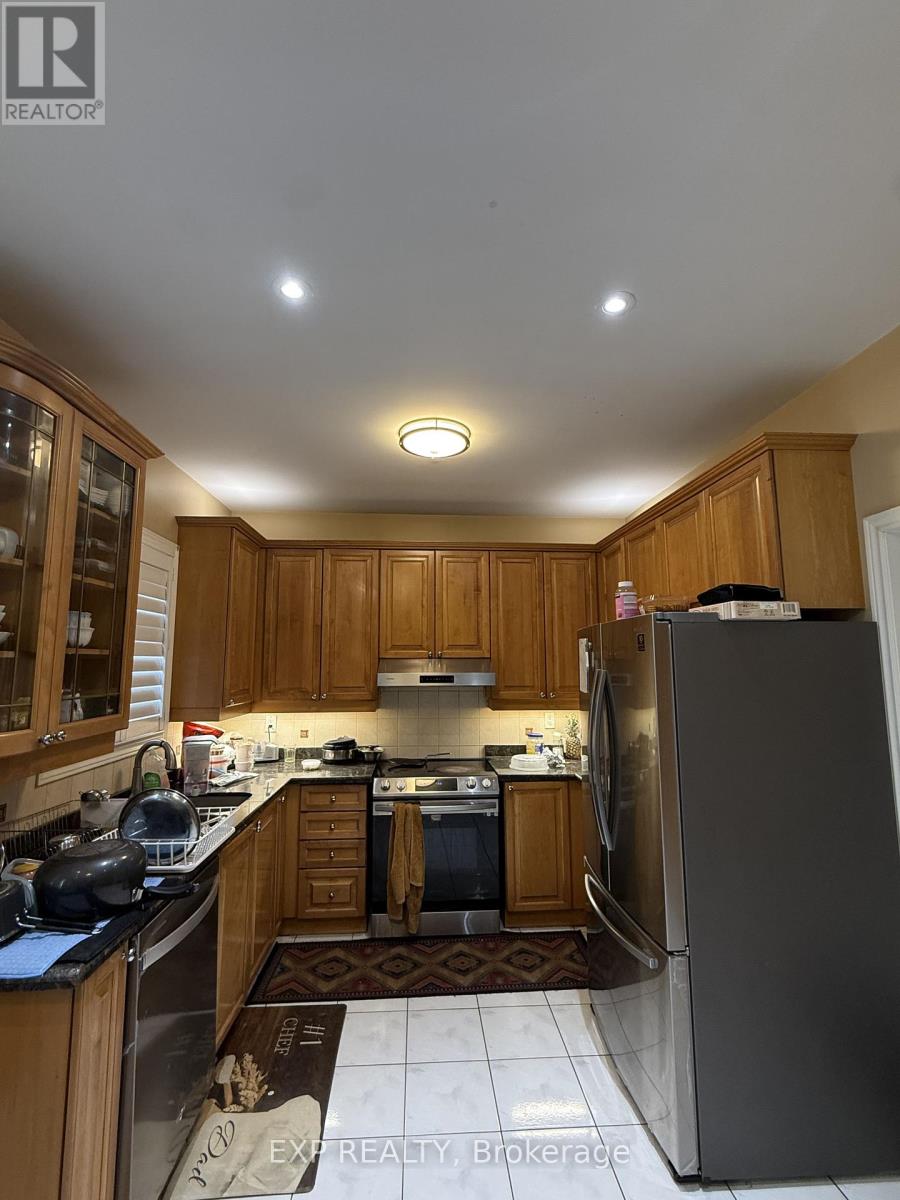 A kitchen with wooden cabinets and a refrigerator.