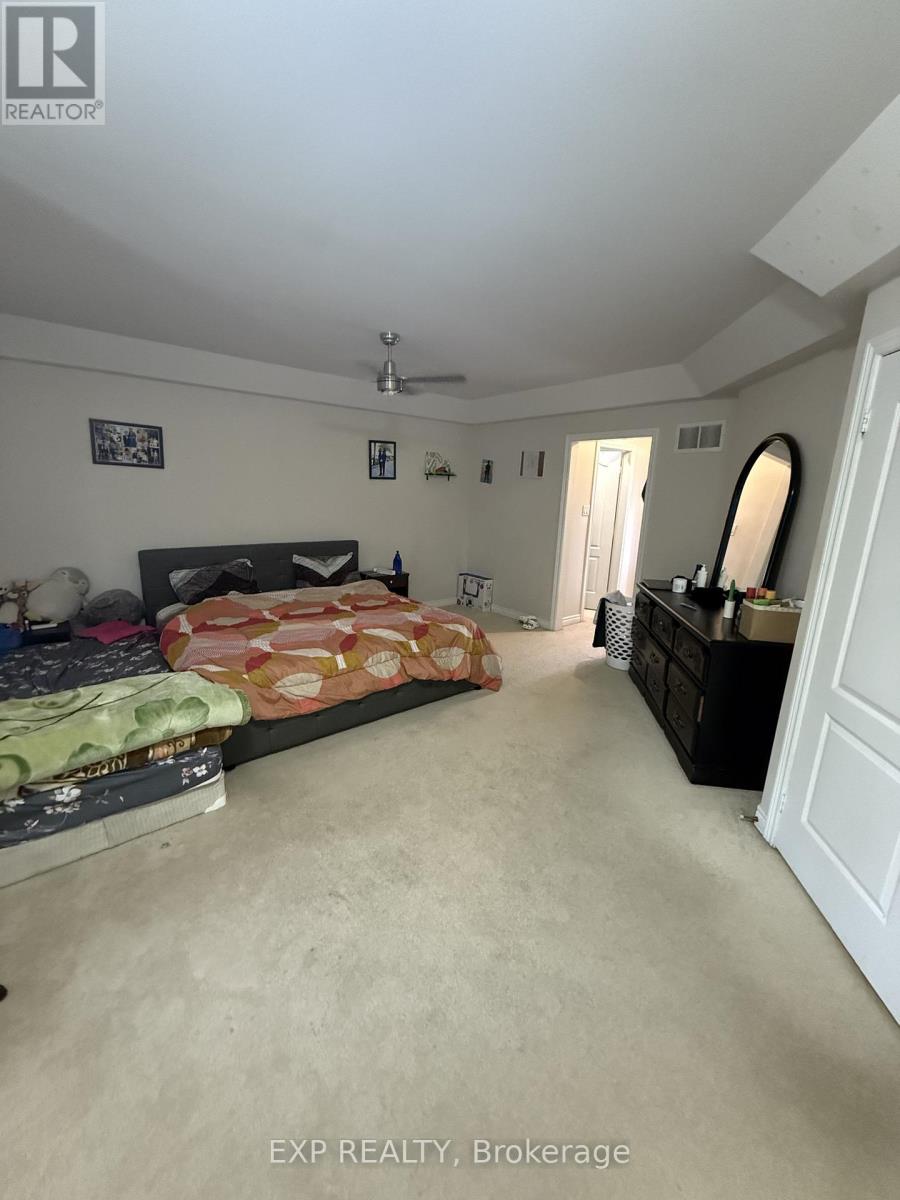 A bedroom with a bed, dresser, and mirror.