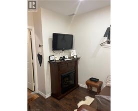 A living room with a fireplace and a flat screen TV mounted above it.