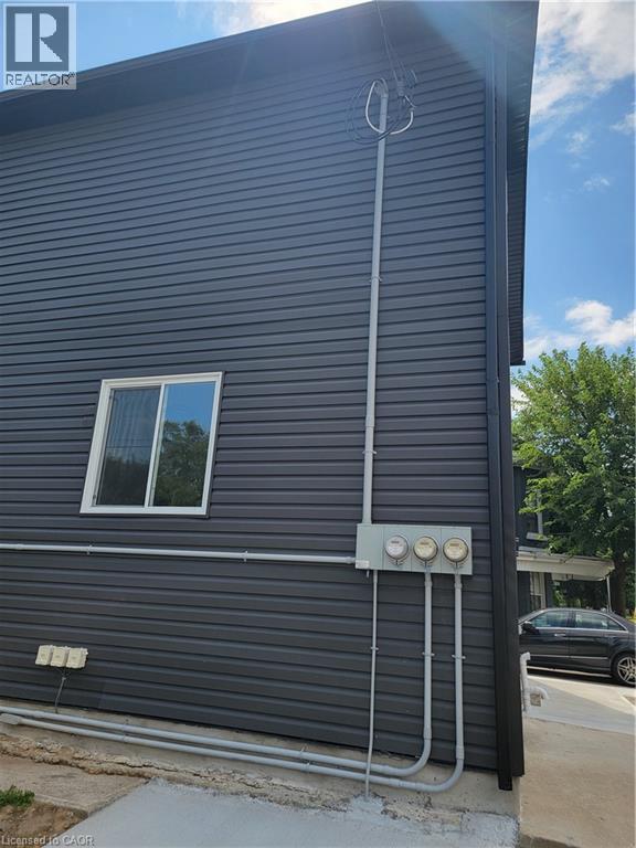 A house with a grey siding and a window.