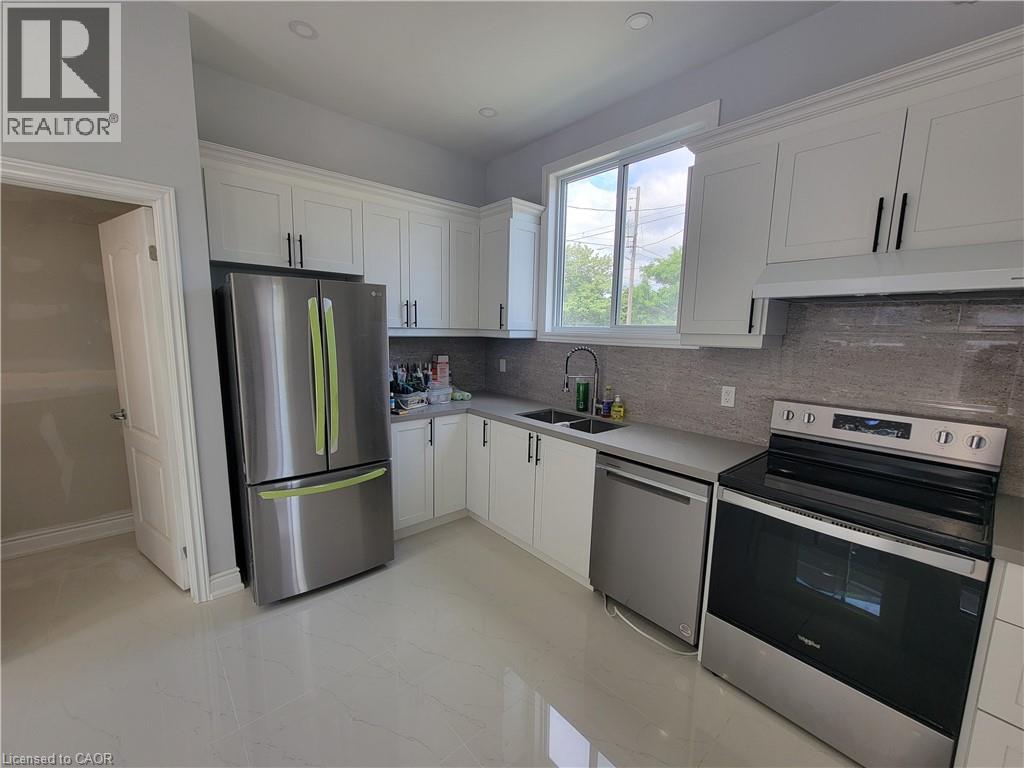 A kitchen with white cabinets and stainless steel appliances.