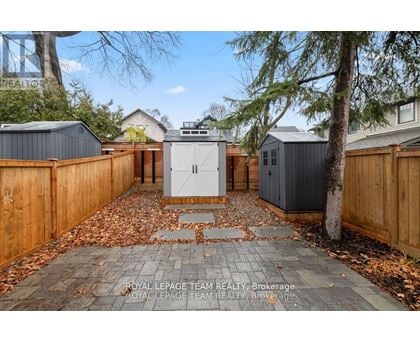 A backyard with a wooden fence and a shed.