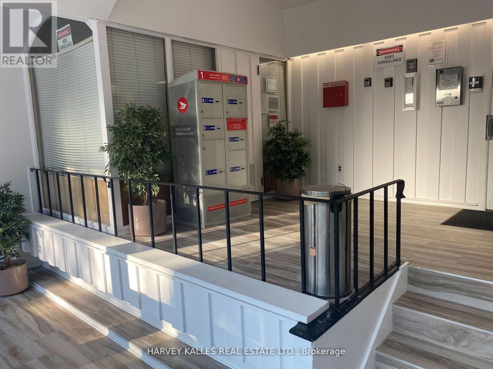 A brokerage office with a reception desk and a mailbox.