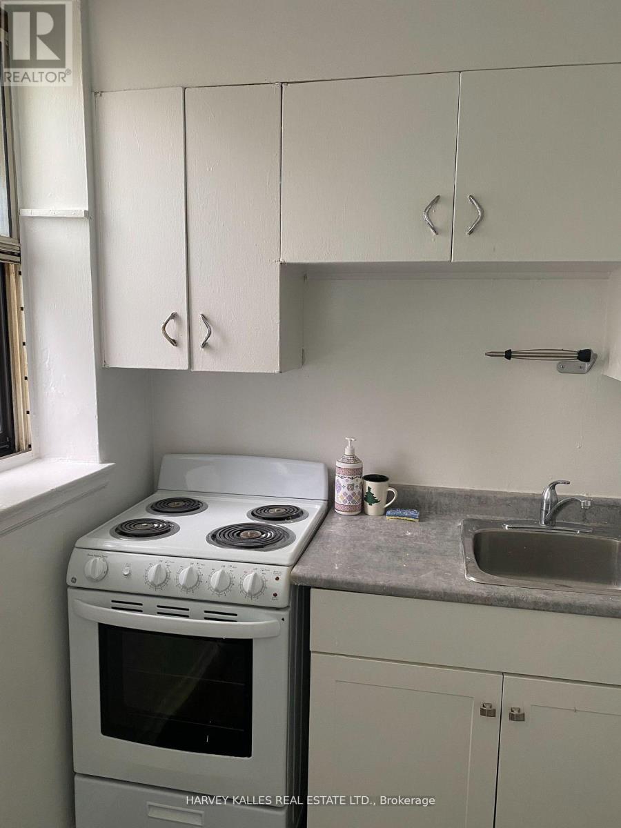 A white stove and sink in a kitchen.